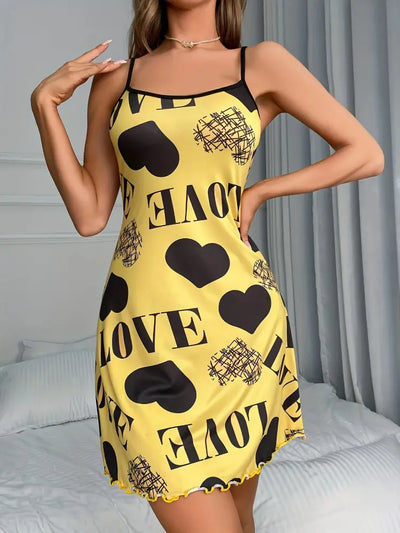 Model posing in yellow love print satin mini nightgown with lettuce hem, hand on hip
