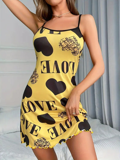 Full-length front view of yellow satin nightgown with love print, model raising one arm