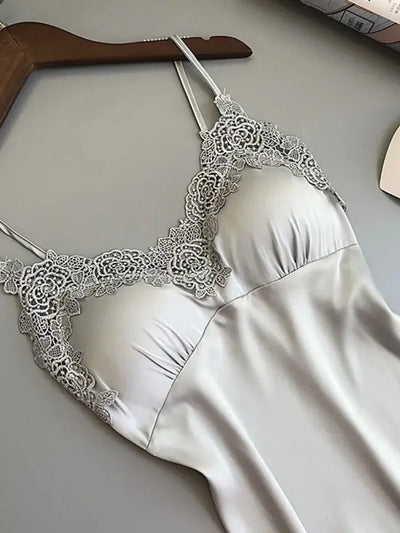 Close-up of gray satin nightgown showing rose lace appliqué at V-neckline and cross-back straps