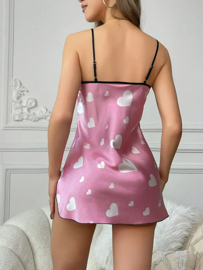 Back view of woman standing in pink heart-print mini nightgown showing adjustable spaghetti straps