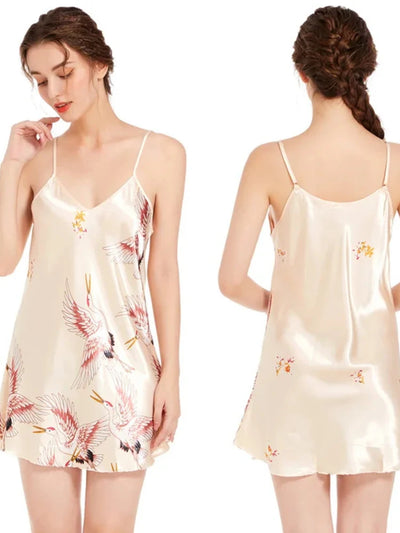Front and back views of a champagne satin crane print mini nightgown with thin adjustable straps on two models.