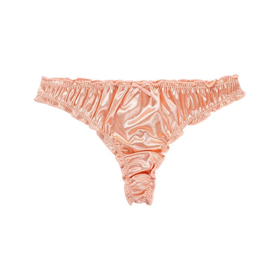 Product shot of peach satin ruffled thong panties with bow detail on white background