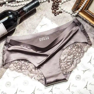 Single taupe satin panty with scalloped lace hip panels flat lay on Paris-print paper
