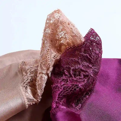 Close-up of scalloped lace edge detail in blush and burgundy satin panty fabric