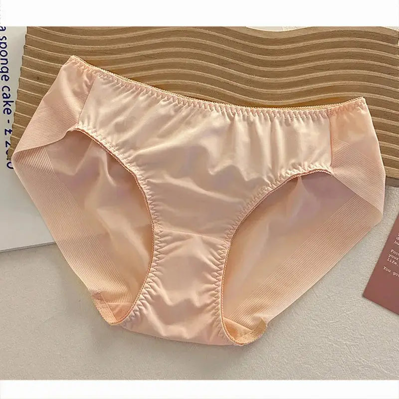 Blush mid-rise satin panties with ruched leg edges, flat-lay on white surface