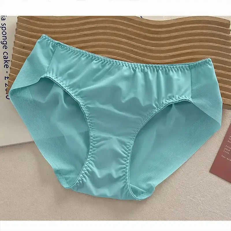 Aqua mid-rise bikini panties with glossy satin finish and gathered elastic edges, flat lay on beige surface