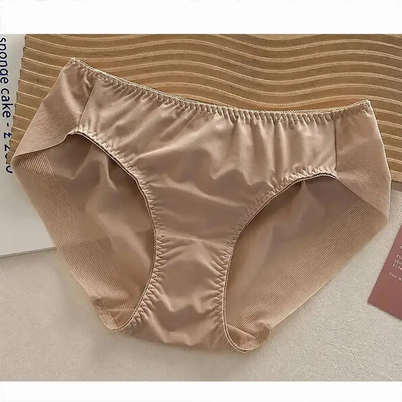 Nude satin bikini panties with foldover elastic waistband, flat-lay product shot on white surface
